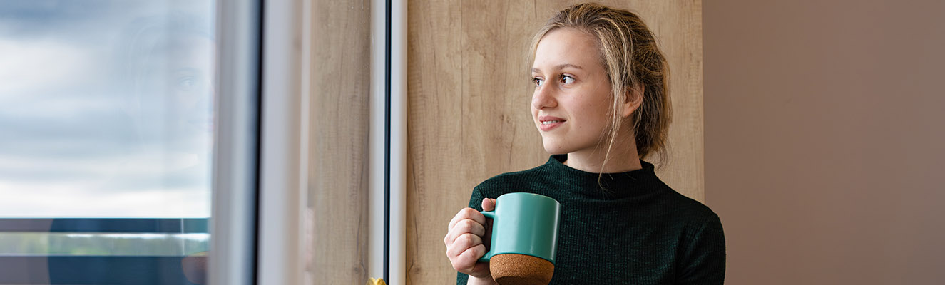 Pensive person enjoying a hot drink
