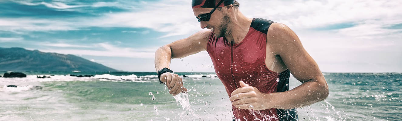 man in swimming suit looking at a watch