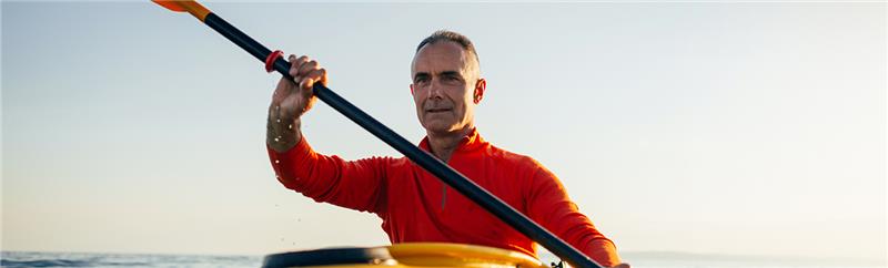 man paddling a canoe