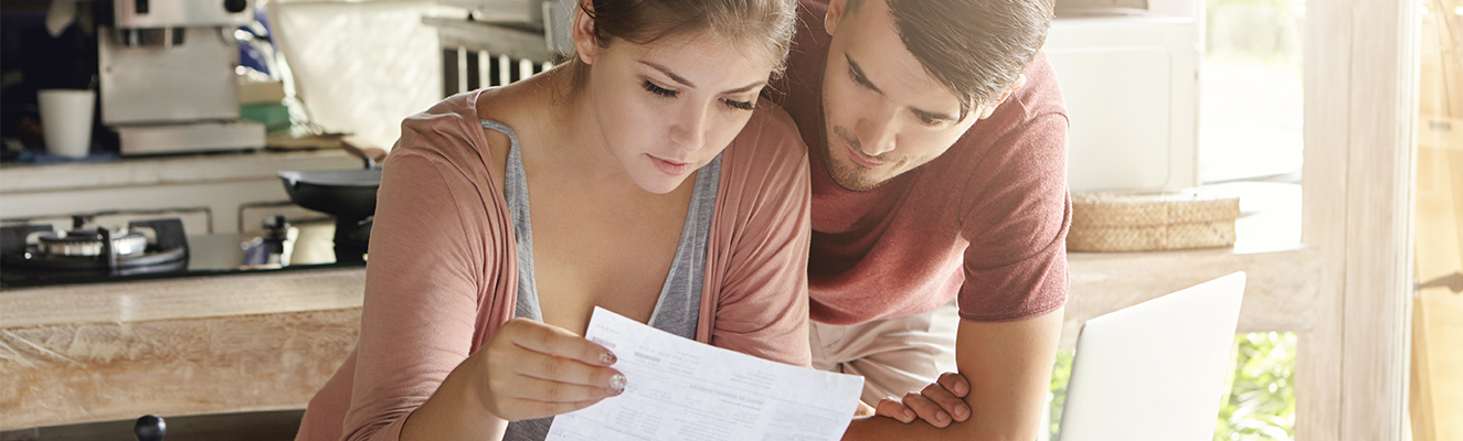 Couple checking papers calculating their finances