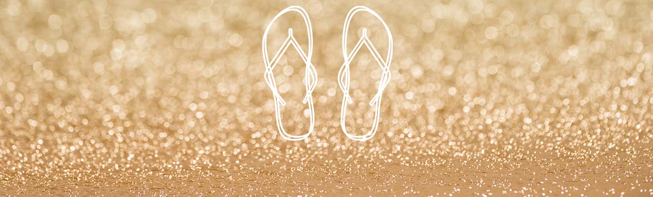 Pair of thongs on sand